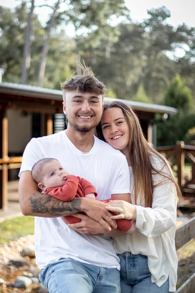 Family photo of young couple and their 3 month old baby boy