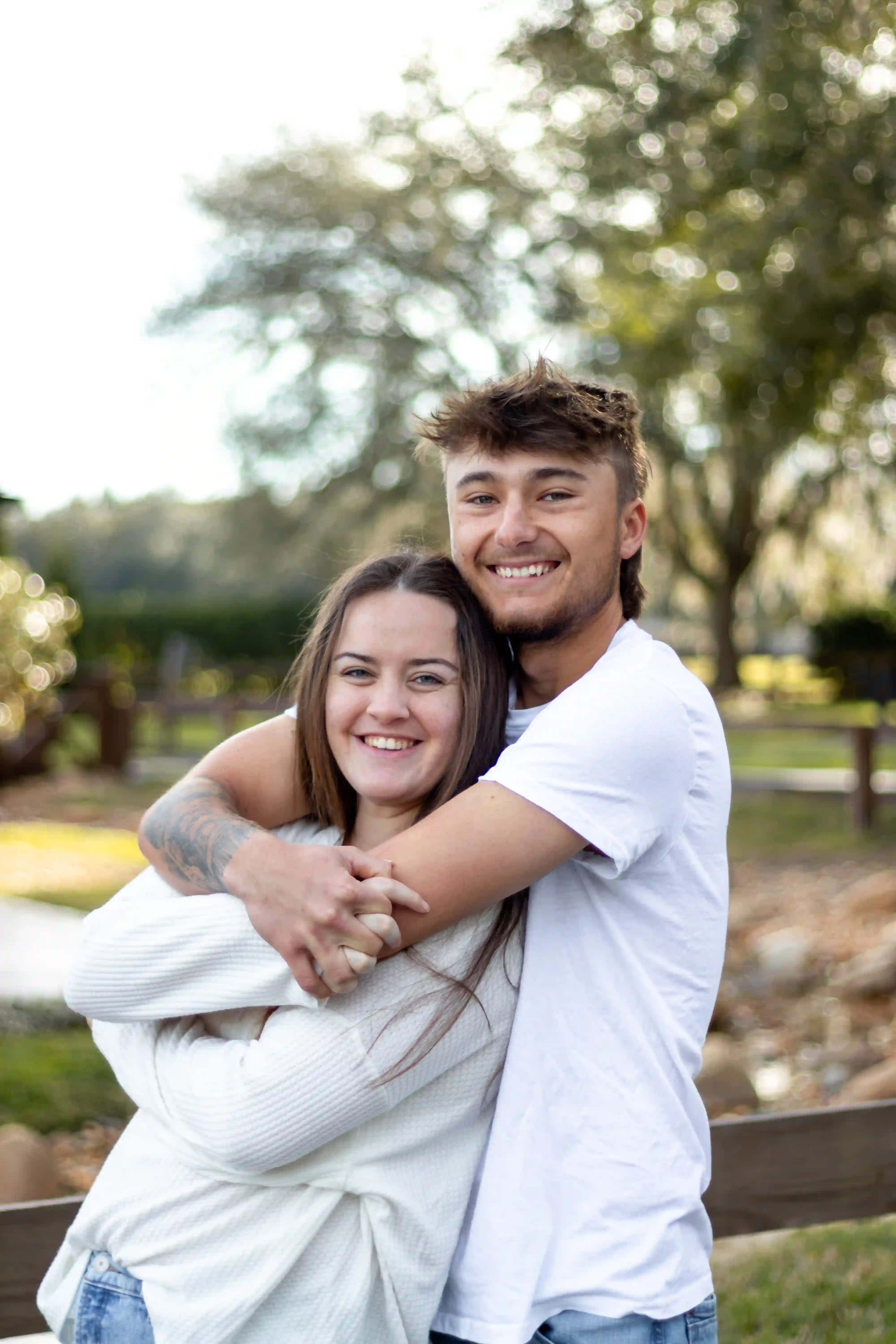 Young family couple hugging in a beautiful rural florida landscape